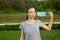 Young woman takes off medical mask and breath deeply and smiling looking aside.