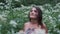 A young woman takes off a medical mask, breathes deeply and smiles while looking at the forest and nature. Healthcare