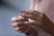 Young woman takes off wedding ring, close up view