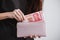 Young woman takes out money chinese yuan banknotes from a wallet. Close up