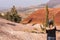 A young woman takes pictures with her smartphone on Paint Cove Trail in Painted Hills