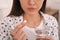 Young woman taking abortion pill, closeup