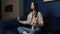 Young woman taking a deep breath whilst meditating in her living room lotus pose yoga relaxation