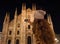 Young woman taking photo of Duomo in the evening, Milan