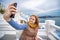 Young woman taking photo selfie at Greece Islands. Santorini, one of the most beautiful travel destinations of the world