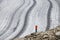 Young woman taking photos at the Aletsch glacier in the Swiss Alps, Europe