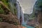 young woman taking picture,Amazing crystalline blue water of Tamul waterfall at Huasteca Potosina in San Luis Potosi, Mexico