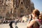 Young woman taking picture of Sagrada Familia, Barcelona, Spain