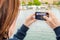 Young Woman Taking Pictures from the Deck of a Ship