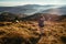 Young woman is taking pictures of a foggy valley in France