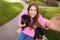 Young woman taking selfie with adorable Brussels Griffon dogs