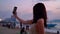 Young woman taking a selfie photo in sunset tropical beach sea view background with her mobile phone. Beautiful Asian