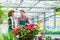 Young woman talking with his friend at his workplace in the flower shop