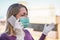 Young woman talking with mobile phone outdoor wearing face mask and latex gloves for Covid-19 virus prevention - Girl speaking