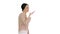 Young woman talking on the phone holding it to her face while walking on white background.