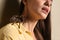 Young woman with tarantula on beige background. Arachnophobia fear of spiders