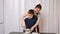 Young woman teaching boy to whisk dough with a whisk