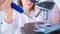 Young woman technician is examining a histological sample, a biopsy in the laboratory of cancer research