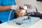 young woman or teenage girl having braces fitted at dentist