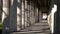 Young woman teenage girl mixed race female wearing camouflage jacket, walking through columns passageway during the day