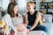 Young woman tender touching partner\\\'s female pregnant belly. Same-sex marriage couple on home living room sofa. health,