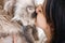 Young woman tenderly kisses her cat