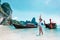 Young woman with thailand longtail boats on beach