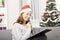 Young woman think about christmas wih list