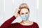 Young woman thinking wearing protective face mask prevent virus infection, pollution