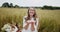 Young woman throwing wheat grains in the air laughing