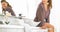 Young woman with toothbrush sitting in bathroom