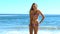 Young woman tossing her hair on the beach