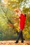 Young woman tossing leaves.