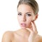 Young woman touching her face and neck. Beauty treatment for young beautiful female face. Skin care, beautician treatments, body