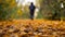 Young woman tourist with a backpack walks on fallen yellow leaves in the forest. Lifestyle hiking concept.