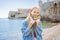 Young woman tourist eating traditional pizza in the old town of Budva. Travel to Montenegro concept