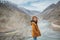 Young woman tourist enjoy traveling at confluence of zanskar and indus rivers in leh.