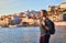 Young woman tourist enjoying beautiful landscape view on the old town Ribeira historical quarter and river Duoro during the