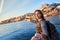 Young woman tourist enjoying beautiful landscape view on the old town Ribeira historical quarter and river Duoro during the