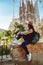 Young woman tourist in front of the famous Sagrada Familia landmark in Barcelona