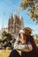 Young woman tourist in front of the famous Sagrada Familia landmark in Barcelona