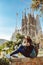 Young woman tourist in front of the famous Sagrada Familia landmark in Barcelona