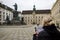 Young woman tourist looking at map, girl visit in  Vienna Hofburg Imperial Palace at courtyard with monument Kaiser Franz I,