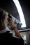 Young woman tourist looking through telescope on top in astronomic observatory