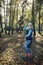 Young woman tourist posing in the autumn nature