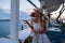 Young woman tourist in straw hat sitting at cliff cafe with sea view at Ermioni, Greece