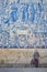 Young woman tourist walking near the church with famous portuguese blue ceramic tiles on the facade traveling in Porto city,