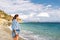 Young woman tourist watching sea landscape, Livadi beach Greece