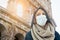 Young Woman Tourist Wearing Face Mask Walks Near the The Roman Coliseum In Rome, Italy