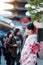 Young woman tourist wearing kimono enjoy in Yasaka pagoda area near Kiyomizu dera temple, Kyoto, Japan. Asian girl with hair style